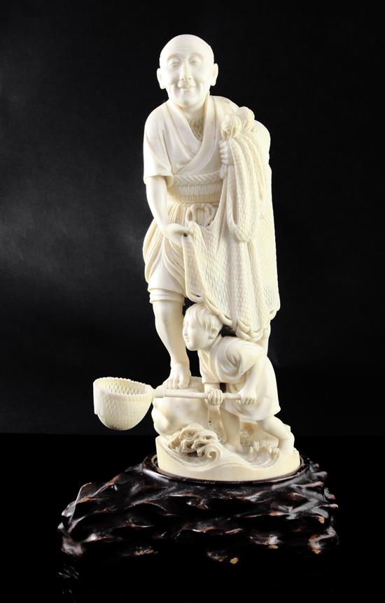 A large Japanese Tokyo School ivory okimono of a fisherman and his son, Meiji period, some damage to boys net